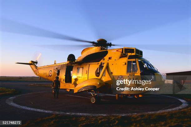 yellow raf helicopter on landing pad - british military stock pictures, royalty-free photos & images