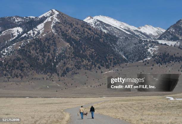 ranchers walking down rural road in montana - prairie dog 個照片及圖片檔