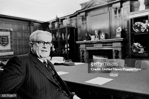English chemist and Chairman of the Football Association, Sir Harold Warris Thompson pictured in a boardroom at the Football Association in London on...
