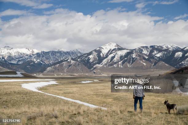 rancher and his dog looking over grassland in montana - prairie dog 個照片及圖片檔