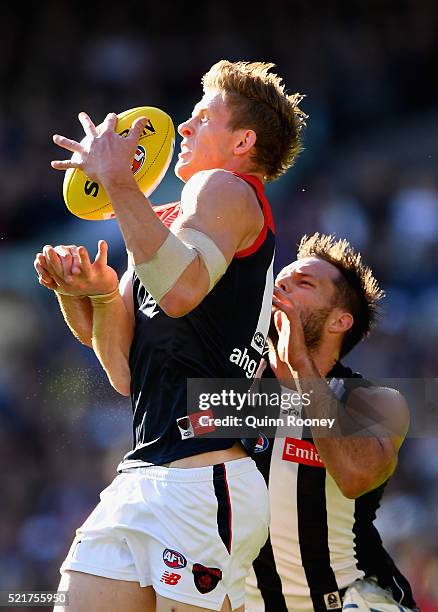 Sam Frost of the Demons attempts to mark infront of Nathan Brown of the Magpies during the round four AFL match between the Collingwood Magpies and...