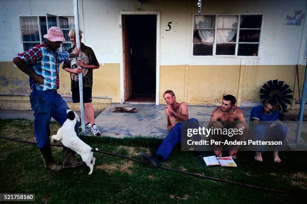 White farm workers relax outside their house after harvesting melons since the early morning in Orania, an all white community in South Africa. About...