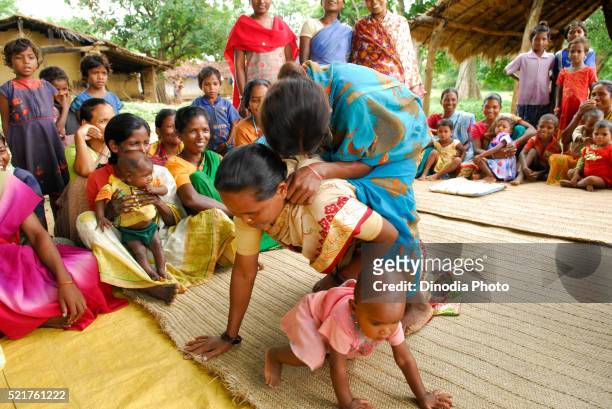 ho tribes women playing piggybacking and sharing medical information, chakradharpur, jharkhand, india - chakradharpur stock pictures, royalty-free photos & images