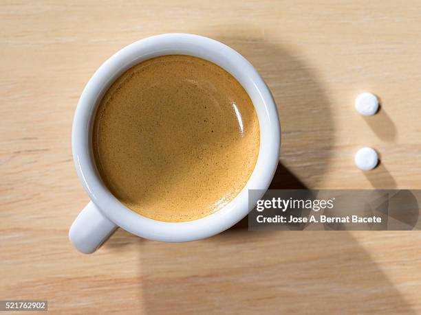 cup of coffee espresso  with tablets of saccharin, on a table of wood - artificial sweeteners stock pictures, royalty-free photos & images