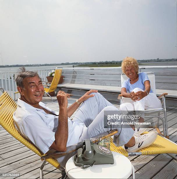 Portrait of American television sports journalist Howard Cosell and his wife, Emmy , as they sit on a wooden deck, West Hampton, New York, July 16,...