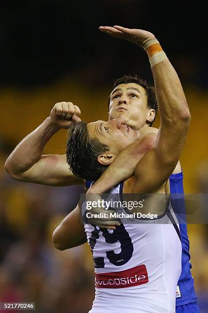 Scott Thompson of the Kangaroos competes for the ball over Matthew Pavlich of the Dockers during the Round 4 AFL match between North Melbourne v...