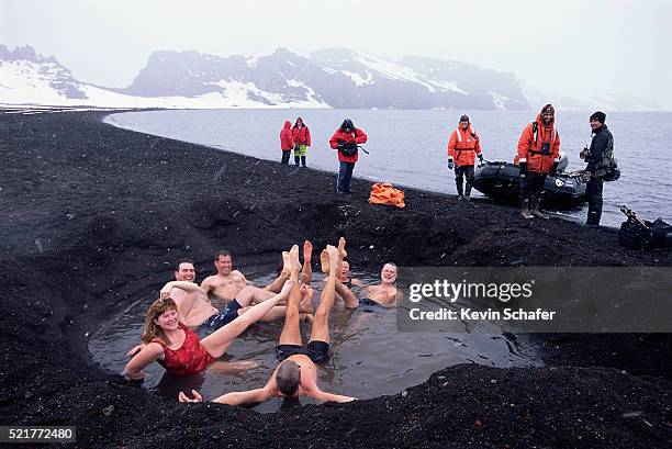 people relaxing in a thermal pool - deception island foto e immagini stock