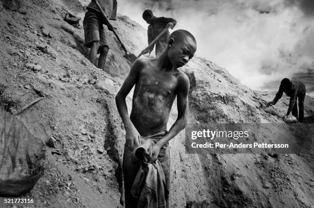 Young boy works among about 4,000 artisan miners dig for copper in Ruashi mine about 20 kilometers outside Lubumbashi, Congo, DRC. Some children as...