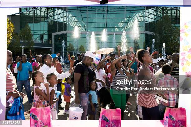 Shoppers attend a promotion for a detergent brand on May 1, 2013 at Maponya shopping Mall, Soweto, South Africa. Maponya is one of several new...