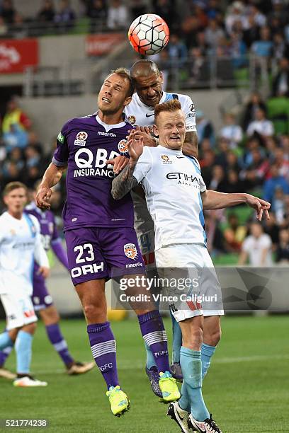 Jack Clisby of Melbourne City, Patrick Kisnorbo of Melbourne City and Krisztian Vadocz of Perth Glory contest for a header during the A-League...