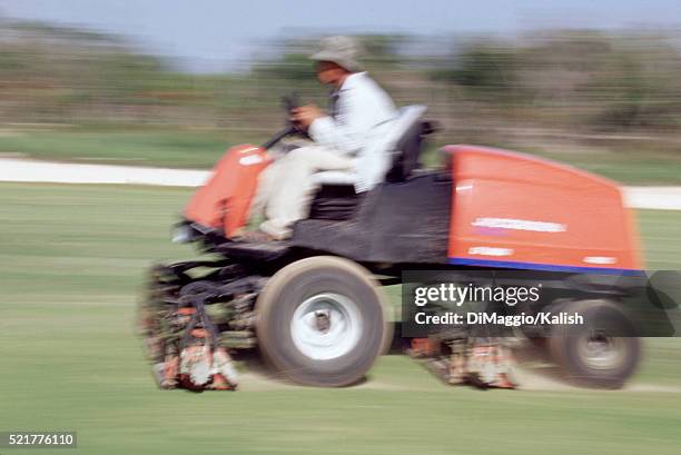 mowing equipment on a golf course - lawn tractor stock pictures, royalty-free photos & images