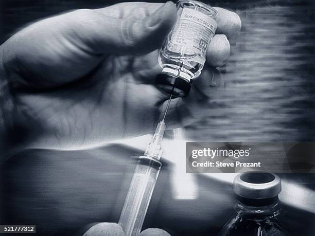 preparing an injection - vintage syringe stock pictures, royalty-free photos & images