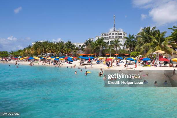 people relax and swim at doctor's cave beach - montego bay stock pictures, royalty-free photos & images