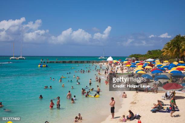 people relax and swim at doctor's cave beach - jamaica people stock pictures, royalty-free photos & images