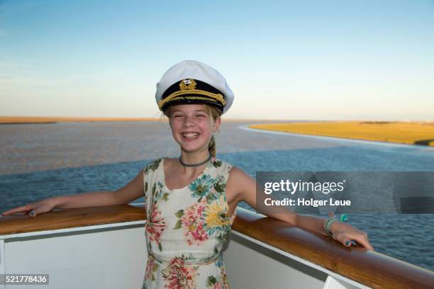 young girl with captain's hat aboard cruise ship ms deutschland - ms deutschland cruise ship imagens e fotografias de stock