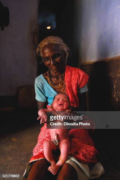ho tribes midwife holding baby, chakradharpur, jharkhand, india - chakradharpur stock pictures, royalty-free photos & images
