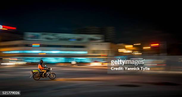 motorcycle taxi in kampala, uganda - uganda stock pictures, royalty-free photos & images