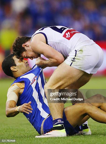 Lachie Neale of the Dockers wrestles Lindsay Thomas of the Kangaroos to the ground during the Round 4 AFL match between North Melbourne v Fremantle...