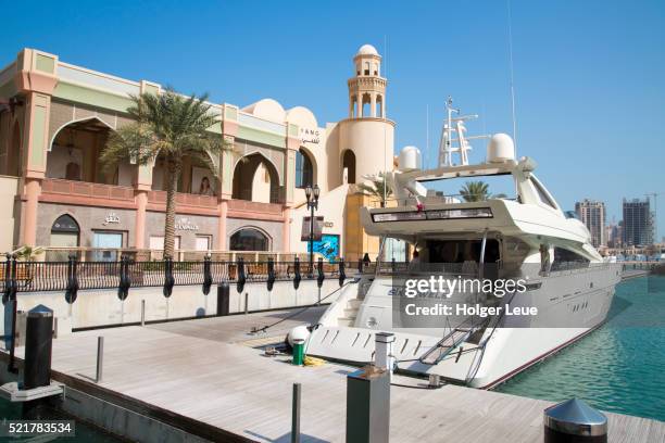 luxury yacht six jewels at porto arabia pier at the pearl qatar development - doha pearl stock pictures, royalty-free photos & images