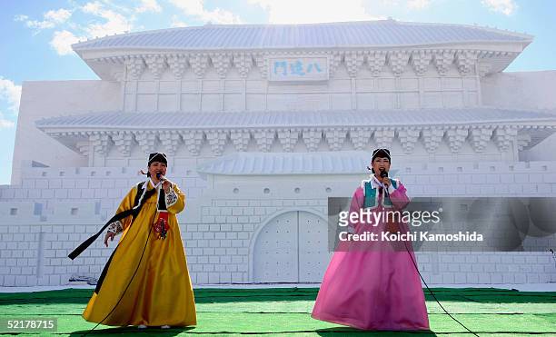 Korean traditional stage performers sing in front of the Hwaseong Fortress "Janganmun" or "Janganmun" at the Makomanai Site of The 56th Sapporo Snow...