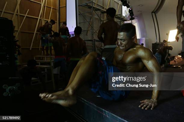 Bodybuilders prepare for judging backstage during the NABBA/WFF Asia-Seoul Open Championship on April 17, 2016 in Seoul, South Korea.