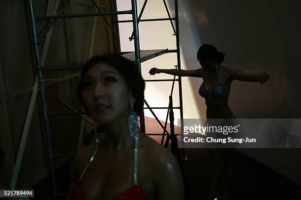 Female bodybuilders prepare themselves for judging backstage during the NABBA/WFF Asia-Seoul Open Championship on April 17, 2016 in Seoul, South...