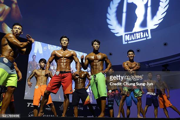 Contestants pose for judges during the NABBA/WFF Asia-Seoul Open Championship on April 17, 2016 in Seoul, South Korea.