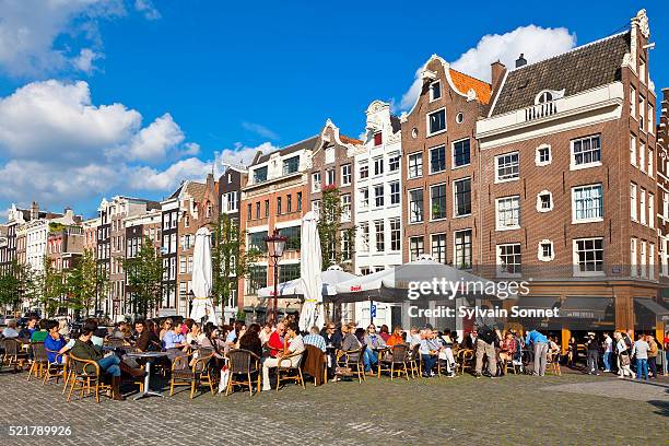 amsterdam, terrace on torensluis bridge - amsterdam tourist stock pictures, royalty-free photos & images