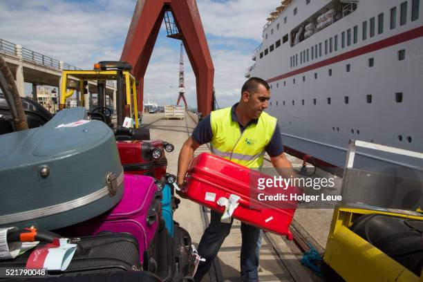 luggage is loaded onto cruise ship ms deutschland (reederei peter deilmann) during embarkation - ms deutschland cruise ship stock pictures, royalty-free photos & images