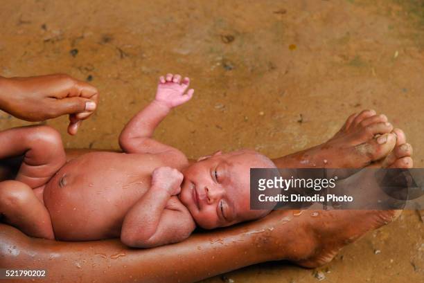 ho tribes mother bathing baby, chakradharpur, jharkhand, india - chakradharpur stock pictures, royalty-free photos & images