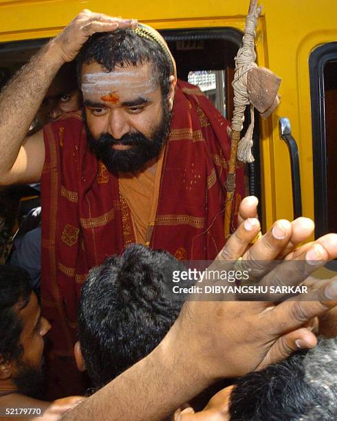 Indian Hindu religious leader Vijayendra Saraswathi gestures as he greets his followers after leaving The Central Prison in Madras 11 February 2005....