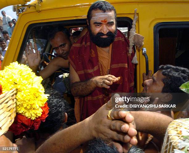 Indian Hindu religious leader Vijayendra Saraswathi gestures as he greets his followers after leaving The Central Prison in Madras 11 February 2005....
