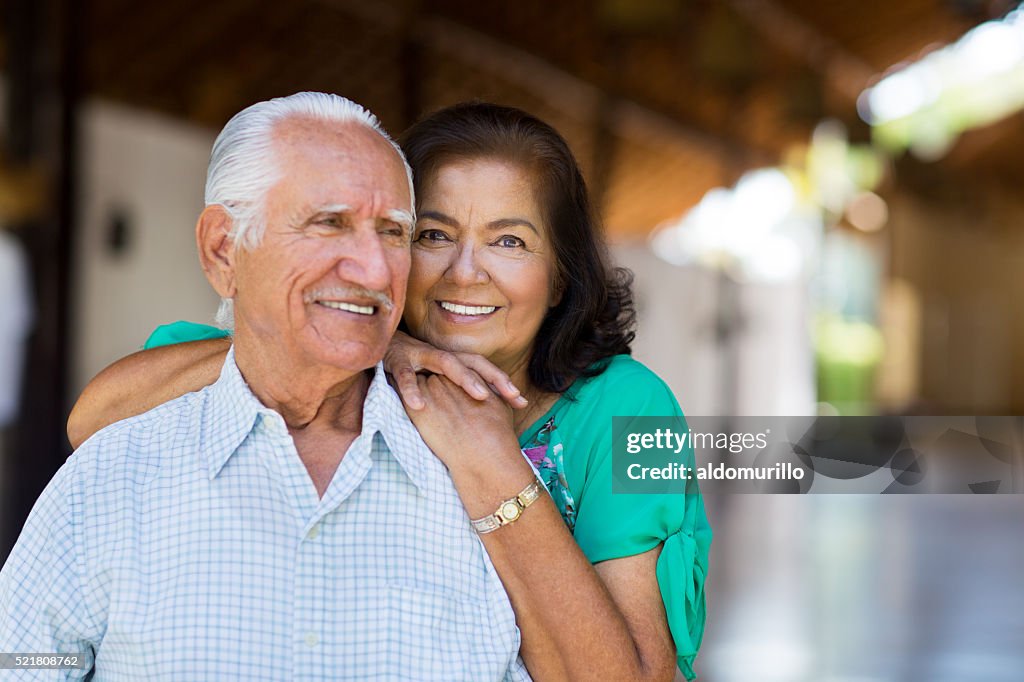 Senior woman placing hands on the shoulder of senior man