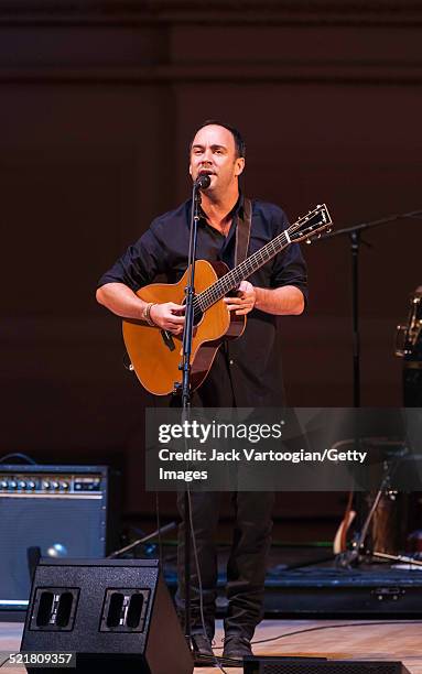 South African-born American musician Dave Matthews plays guitar as he performs onstage at the 'Twenty Years of Freedom' concert during the 'Ubuntu:...