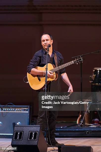 South African-born American musician Dave Matthews plays guitar as he performs onstage at the 'Twenty Years of Freedom' concert during the 'Ubuntu:...