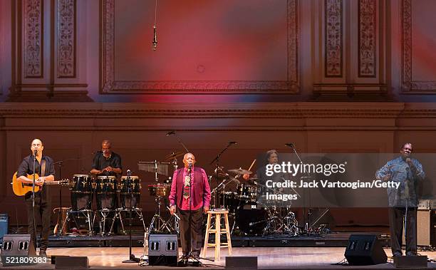 South African composer, bandleader, and musician Hugh Masekela plays fluegelhorn as he leads his band onstage at the 'Twenty Years of Freedom'...