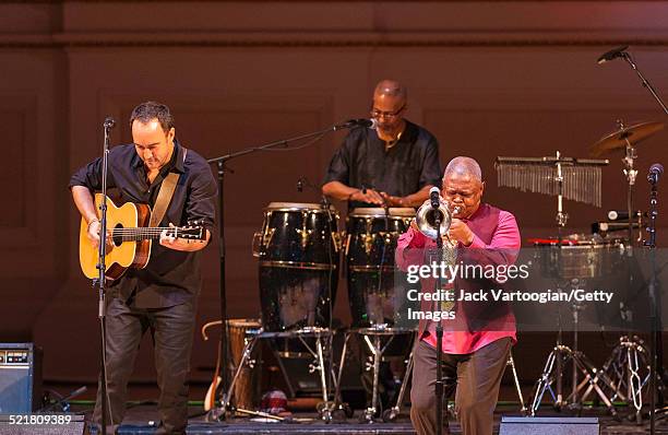 South African-born American musician Dave Matthews plays guitar as a special guest of composer, bandleader, and musician Hugh Masekela onstage at the...