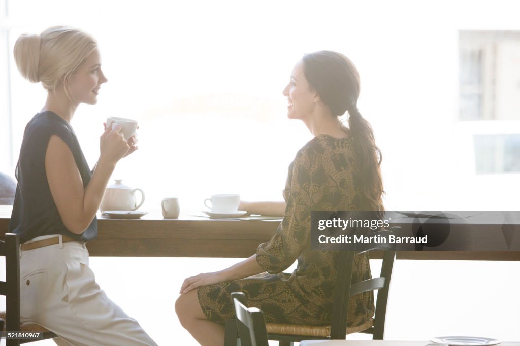 Women having coffee together at cafe