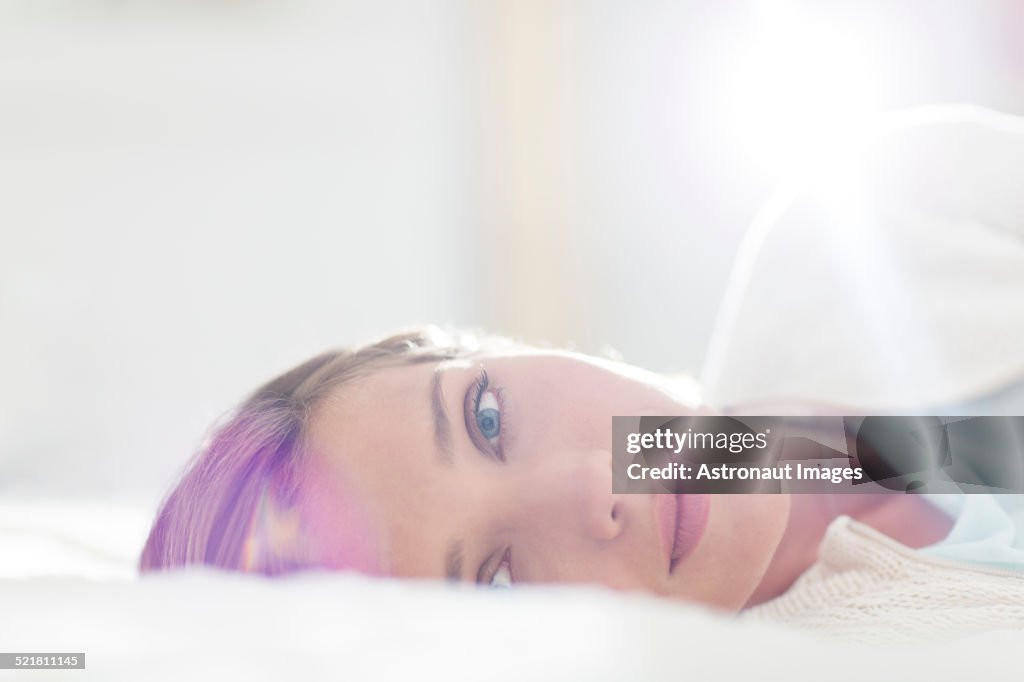 Close up of woman laying on bed