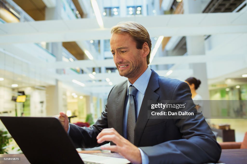 Businessman worried while using laptop