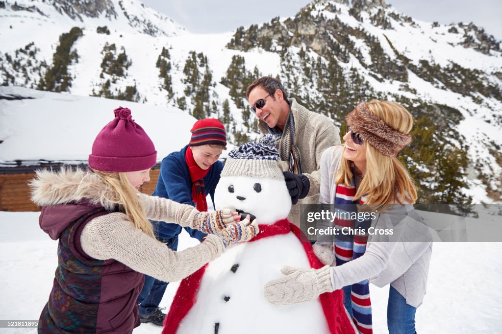 Family building a snowman together