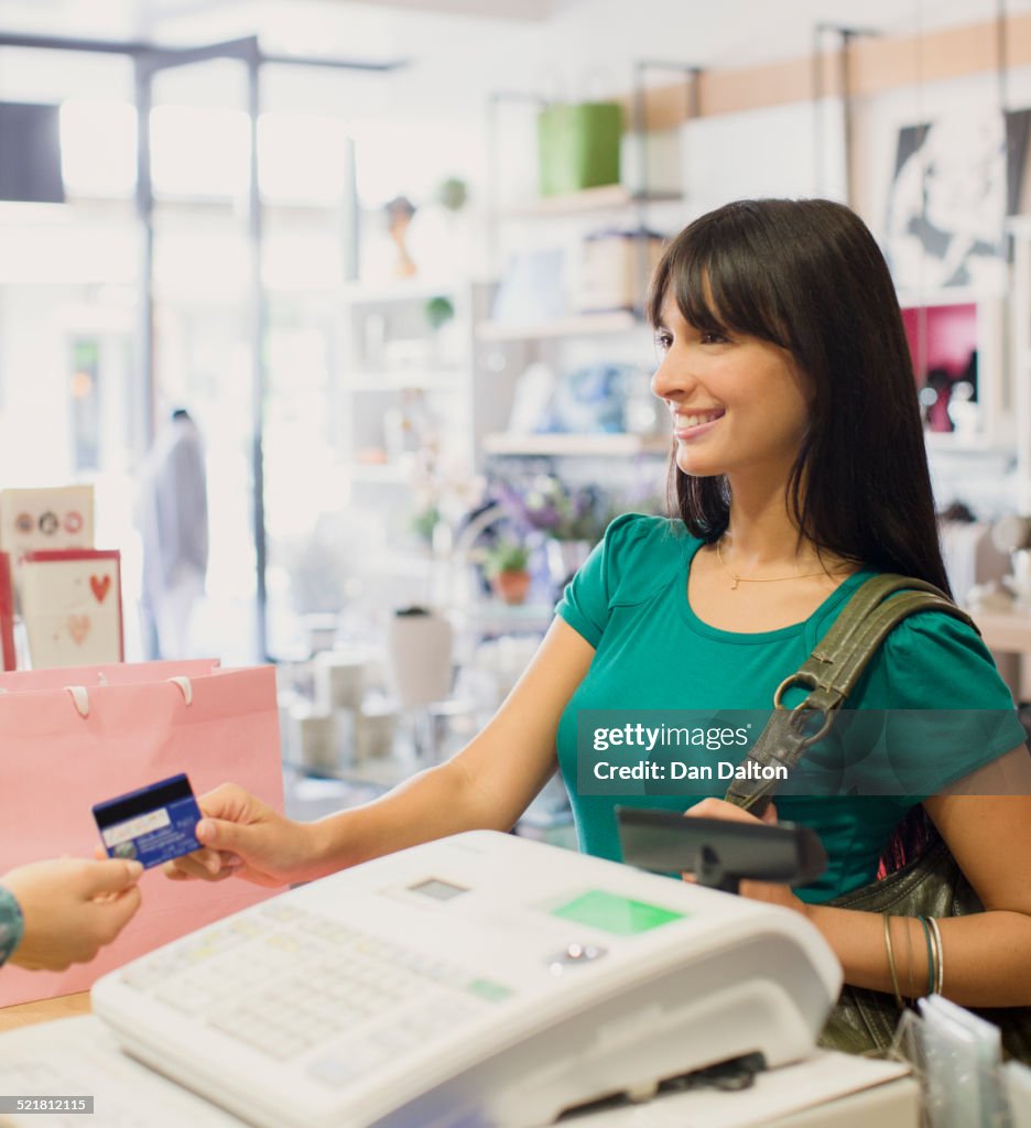 Woman paying with credit card in store