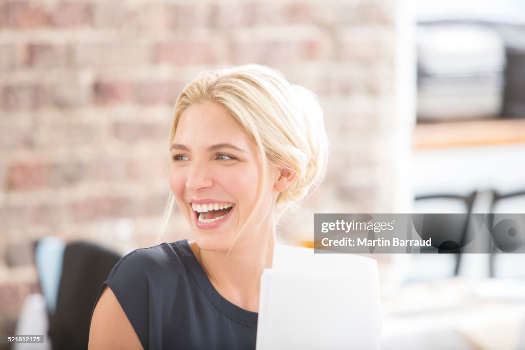 Woman laughing in office