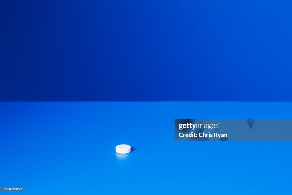 Close up of prescription pill on blue counter