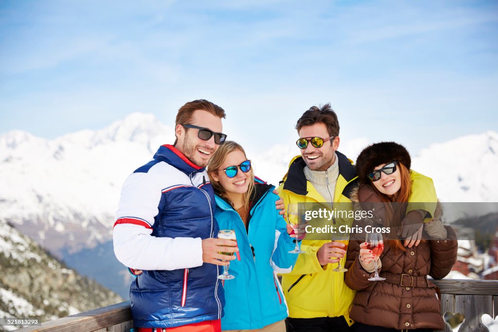 Friends celebrating with drinks in the snow