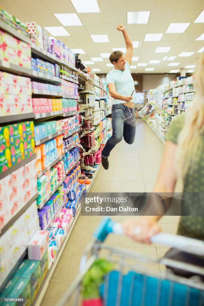 Man jumping for joy in grocery store