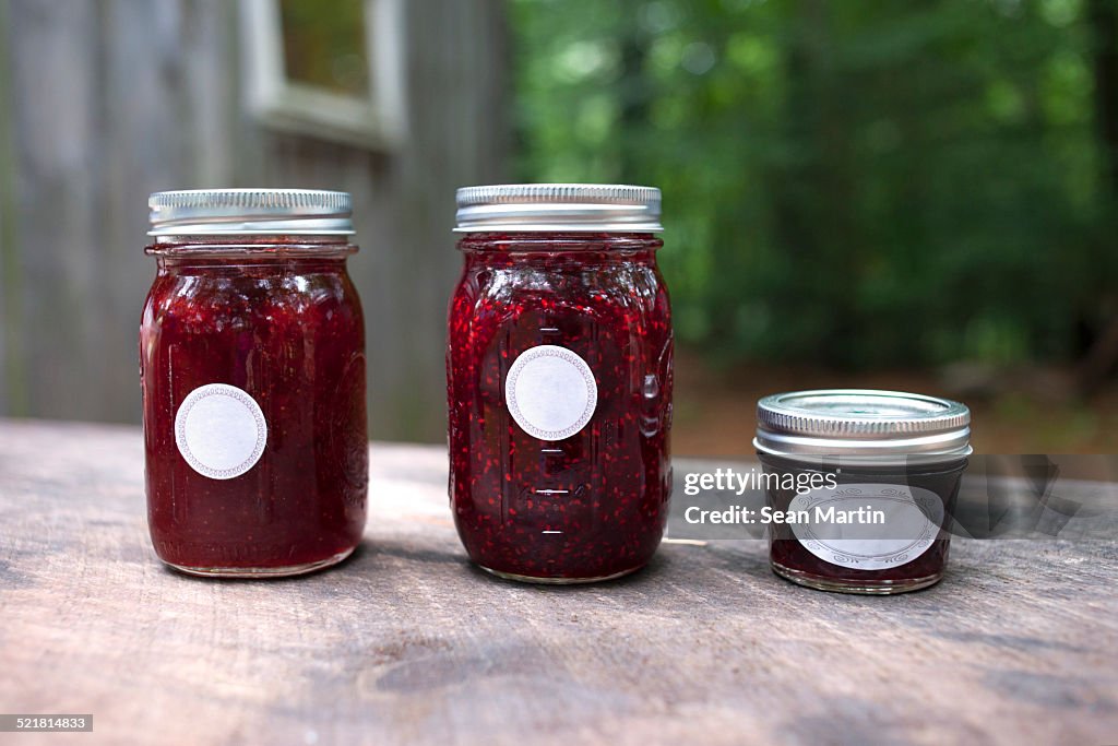 Three jars of jam on garden table