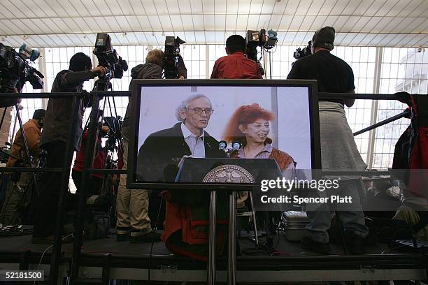 Viewed from a monitor, artists Christo and Jeanne-Claude announce the completed installation of "The Gates, Central Park, New York City, 1979-2005"...