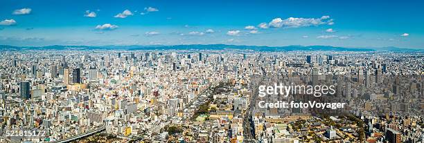 aerial panorama over osaka crowded cityscape skyscrapers and highways japan - osaka prefecture stock pictures, royalty-free photos & images