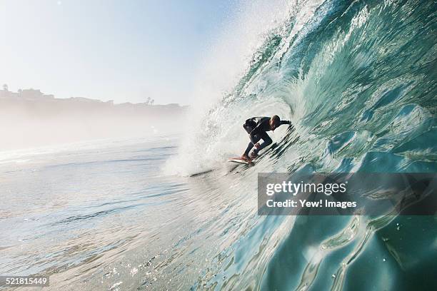 mid adult man surfing rolling wave, leucadia, california, usa - rolling fotografías e imágenes de stock